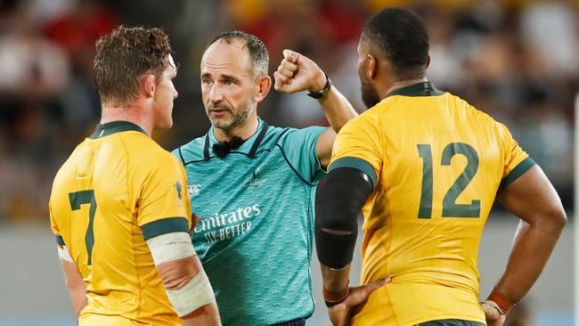 Australia's flanker Michael Hooper (L) and Australia's centre Samu Kerevi (R) listen to French referee Romain Poite (C)   during the Japan 2019 Rugby World Cup Pool D match between Australia and Wales at the Tokyo Stadium in Tokyo on September 29, 2019. (Photo by Odd ANDERSEN / AFP)