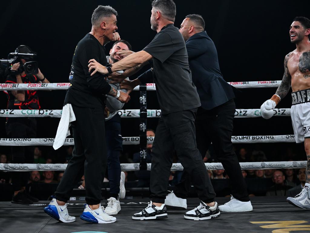 Tommy Mercuri (l) is struck by Michael Zerafa’s brother Jason post fight. Picture: Grant Trouville