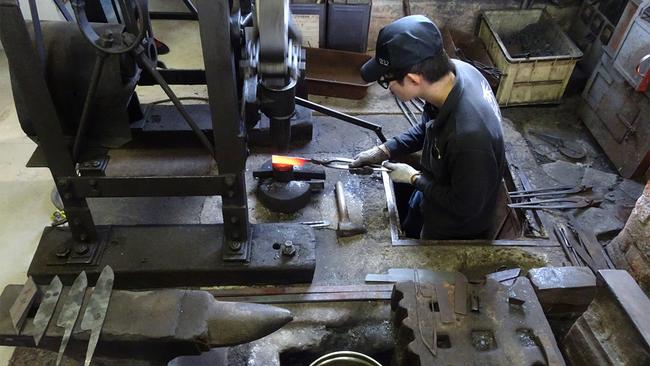 A knife-maker at Ryusen Factory. Picture: Greg Goodmacher
