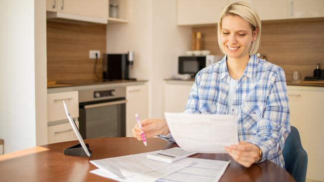 Woman is organizing finances and the household budget; ; income tax return bills generic