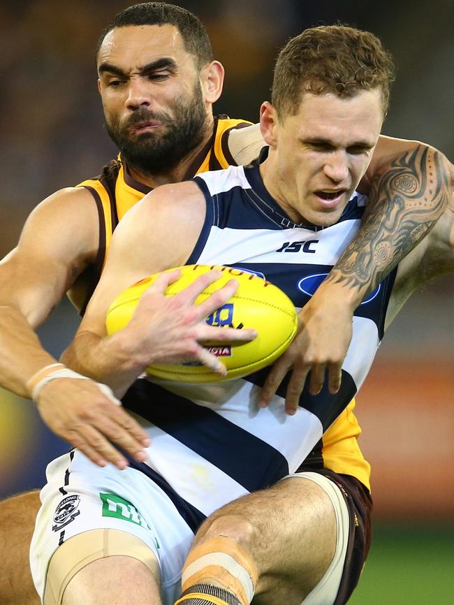 Joel Selwood cops a high tackle from Hawk Shaun Burgoyne. Picture: Michael Klein