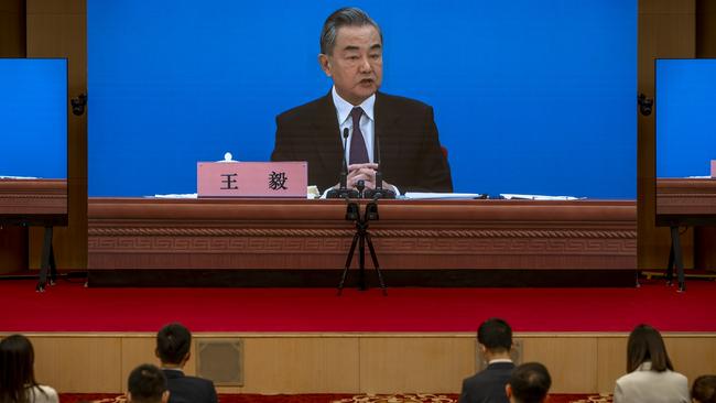 Chinese Foreign Minister Wang Yi, on screen, addresses journalists at the Media Centre in Beijing, China, on Monday night. Picture: Getty Images