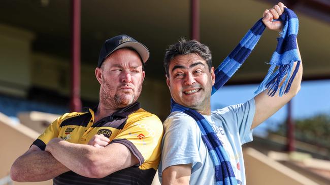 Glenelg No. 1 ticket holder Andrew 'Cosi' Costello hams it up with Sturt tragic David Penberthy. Picture: Russell Millard Photography