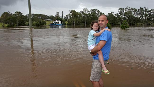 John and Zoe Vaisutis at the Brisbane River near the estate where the country club once operated. The developer of an estate on the site will to install a flood siren. Picture: Tim Marsden