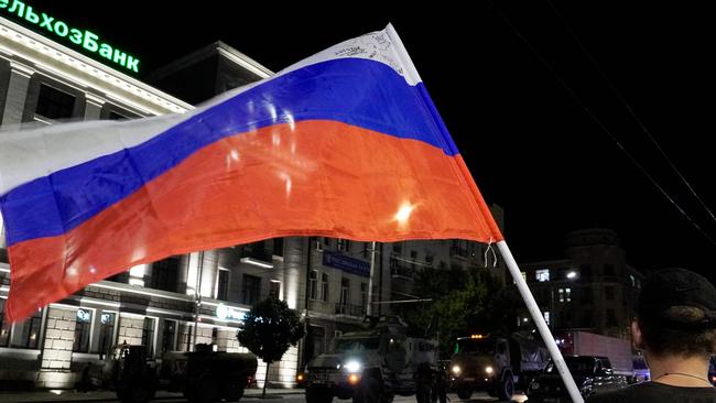 A man waves the Russian national flag as the members of Wagner group prepare to return to their base in Rostov-on-Don after the failed coup. Picture: Stringer/AFP