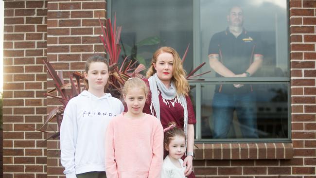 FIFO worker James in quarantine at his home in Launceston with his wife Jarrah and their children Harper, 11, Olivia, 9, and Quinn, 4, outside. Picture: PATRICK GEE