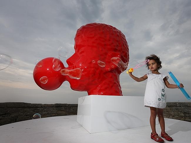 josie Diaz (3) blowing bubbles at Bubble No:5 by artist Qian Sihua.