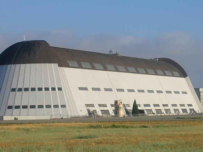 This NASA image taken in 2013, shows Hangar One at Moffett Field, California. Ever-growing Google now has an airport to its name: the Internet giant has signed a 60 year lease to run a NASA airbase that comes with massive hangars for dirigibles. Google subsidiary Planetary Ventures plans to use the historic Moffett Field in Silicon Valley for research and development in space exploration, aviation, robotics and other emerging technologies, according to a NASA statement. The company already uses Moffett for its top executive's jets: the field is located on the southern end of San Francisco Bay just a 10 minute drive from the Googleplex headquarters. Last year Google put on hold a project for a new set of offices at the NASA Research Park, halfway between the airport and Google's headquarters. Now it has pledged to pay $1.16 billion to run the entire 405 hectare (1,000 acre) facility for 60 years, and spend $200 million to upgrade it and restore three huge pre-World War II wooden blimp hangars, with the largest one covering 3.2 hectares. AFP PHOTO/ NASA Ames Research Center/HANDOUT = RESTRICTED TO EDITORIAL USE / MANDATORY CREDIT: "AFP PHOTO HANDOUT-NASA /AMES RESEARCH CENTER/PHOTOGRAPHER"/ NO MARKETING - NO ADVERTISING CAMPAIGNS/ – NO A LA CARTE SALES / DISTRIBUTED AS A SERVICE TO CLIENTS / =