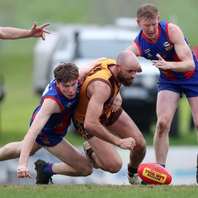 Kiewa-Sandy Creek’s Mitchell Paton is tackled by Beechworth’s Liam Stephens.