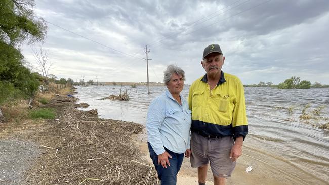 Joanne and Barry Pfeiffer in front of their farm at Murray Bridge which is underwater after the Long Flat levee breached on January 7. Photo: Dylan Hogarth.