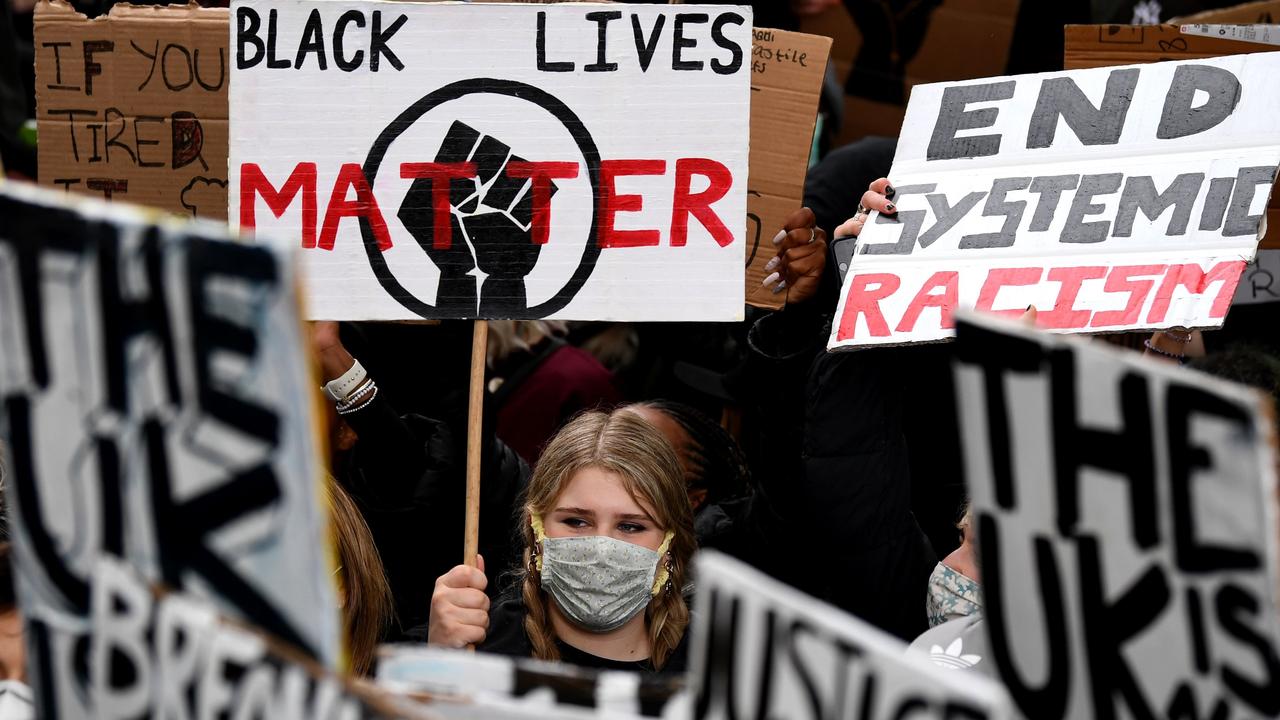 Protesters hold placards calling for justice. Picture: Daniel Leal-Olivias/AFP
