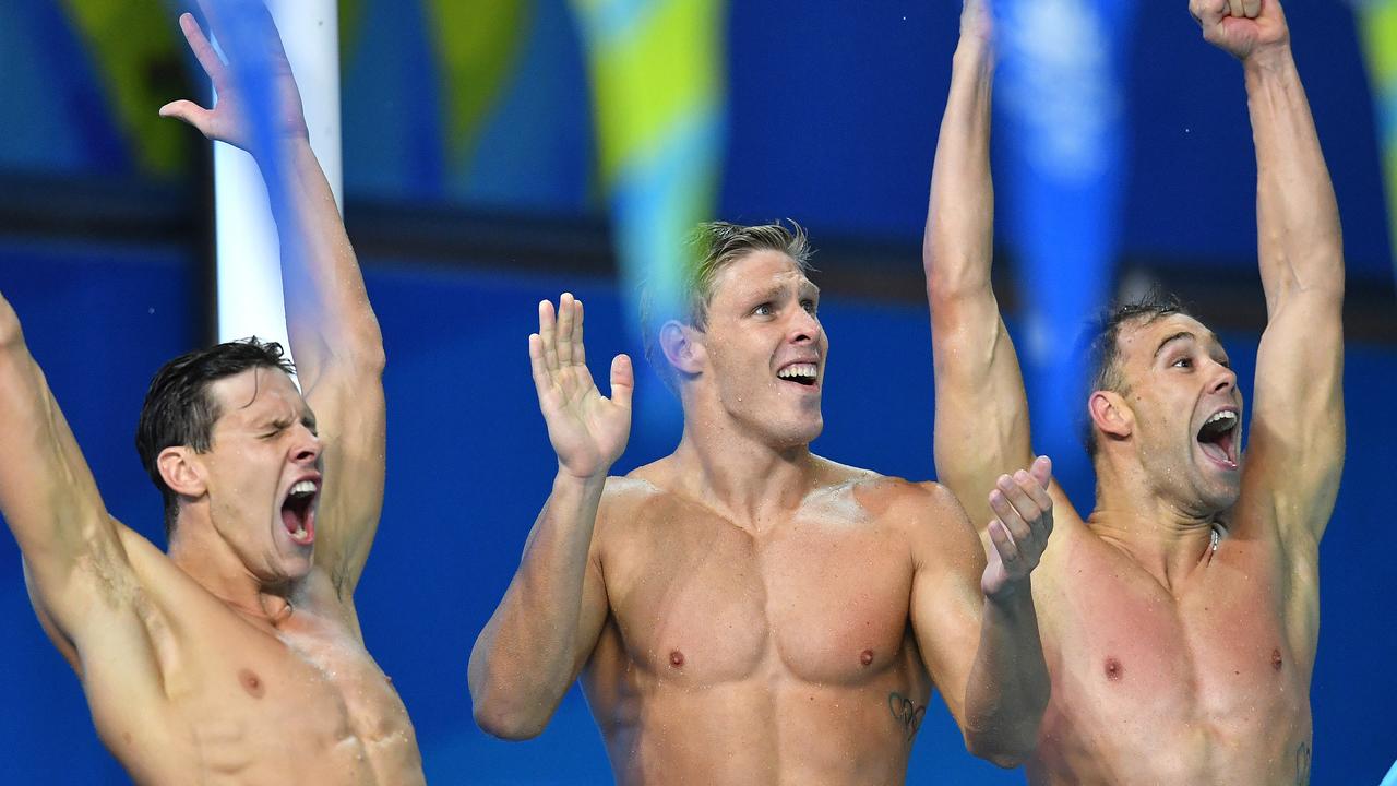 Mitch Larkin celebrates alongside Jake Packard and Grant Irvine after winning gold in the 4x100m medley relay.