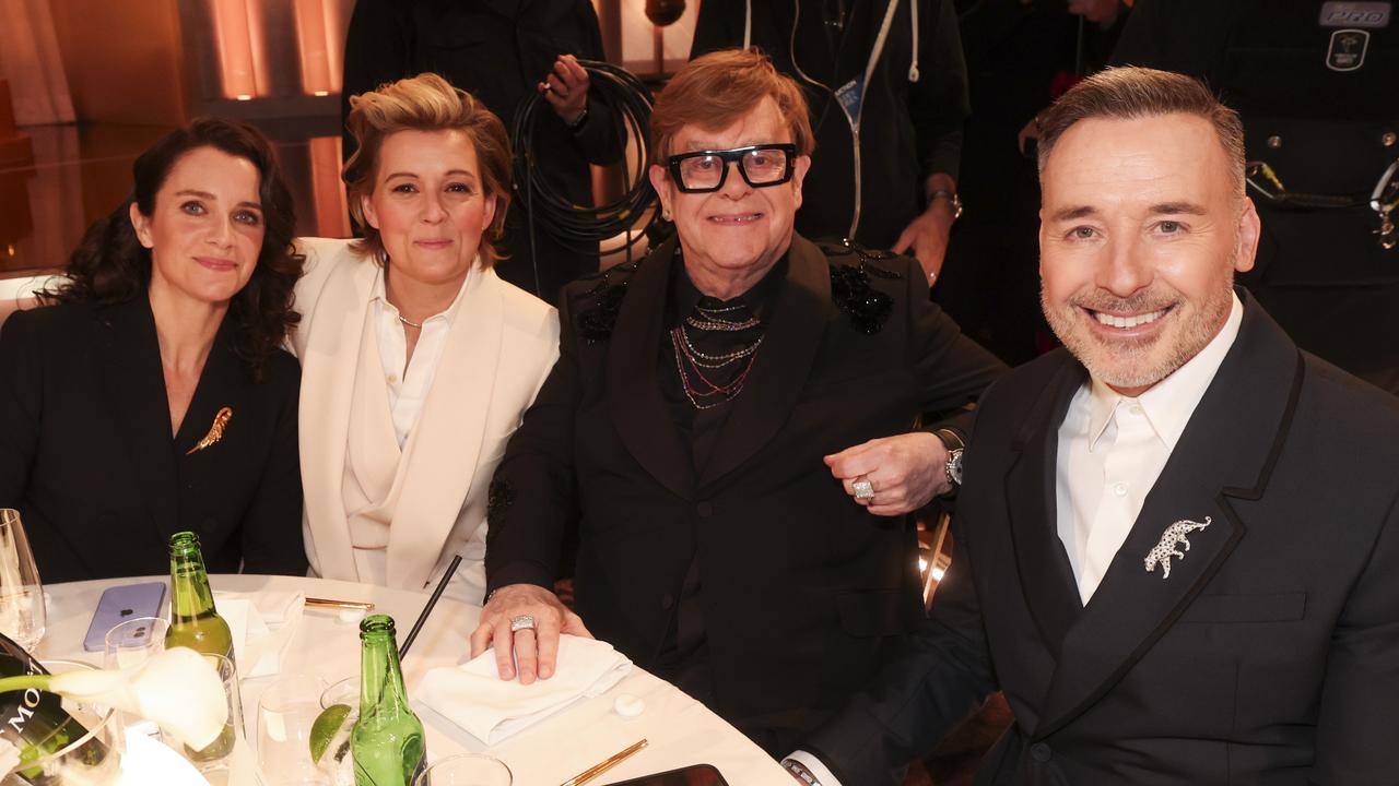 The “family” of Catherine Shepherd, Brandi Carlile, Elton John and David Furnish at the Golden Globes in January. Picture: Getty.