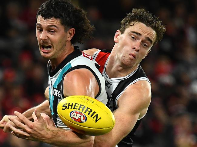 MELBOURNE, AUSTRALIA - APRIL 28: Darcy Byrne-Jones of the Power handballs whilst being tackled by Ben Paton of the Saints during the round seven AFL match between St Kilda Saints and Port Adelaide Power at Marvel Stadium, on April 28, 2023, in Melbourne, Australia. (Photo by Quinn Rooney/Getty Images)