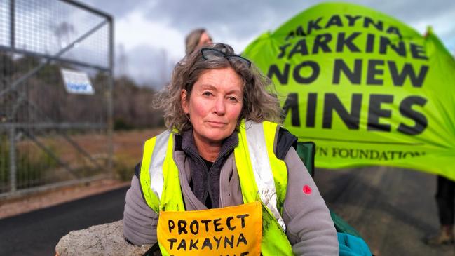 Emma Haswell protests at the entrance to the Venture Minerals mine site at Riley Creek by attaching herself to a concrete barrel. Picture: Bob Brown Foundation