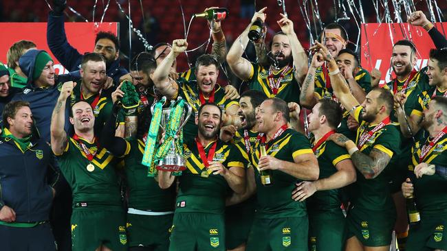 Cameron Smith of Australia lifts the trophy with teammates after victory in the Four Nations final against New Zealand.