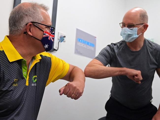 Prime Minister Scott Morrison bumps elbows with Professor Paul Kelly after they both received a dose of the Pfizer/BioNTech Covid-19 vaccine in February. Picture: AFP