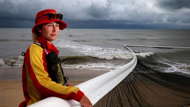 Holloways Beach lifeguard Lucy Chapman checks the nets as surf pounds the beach front PICTURE: ANNA ROGERS