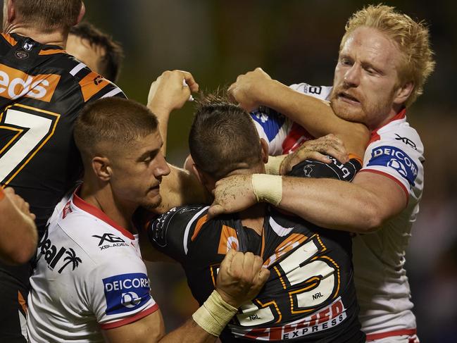 Wests Tigers half Josh Reynolds scuffles with Dragons forward Wade Graham. Picture: Getty Images