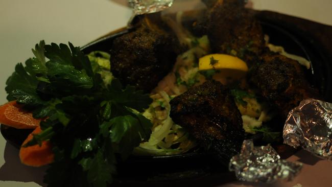 Lamb cutlets marinated with yogurt and spices, cooked in clay oven, served with mint sauce ($20.90 for four pieces) from Castle Taj Indian Restaurant.