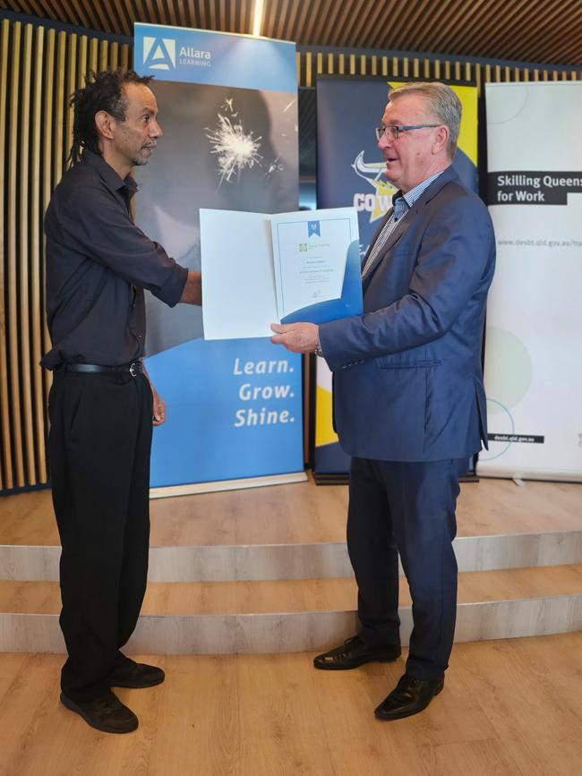 Richard O'Brien receiving his graduation certificate from Mundingburra MP Les Walker as part of the Dream, Believe, Achieve program.