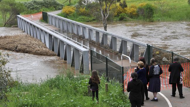 Residents watch rivers rise with storm water in the town of Gawler, South Australia. Picture: AAP Image/David Mariuz