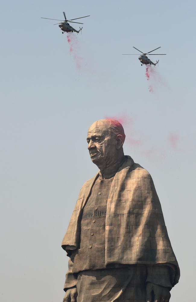 Indian Air Force helicopters shower rose petals on the Statue of Unity as it is unveiled. Picture: Sam Panthaky/AFP