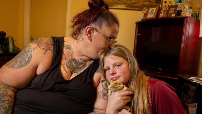 Amanda Johnston with Ben Hickey’s niece Felicity and pet Bearded Dragon, Spyke. Ben fell asleep with his partner Amanda on a Sunday night but he never woke up. Picture: Brett Hartwig