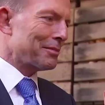 Tony Abbott eats an onion