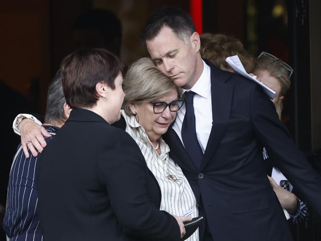 Chris Minns comforting a guest at his father’s funeral. Picture: Richard Dobson