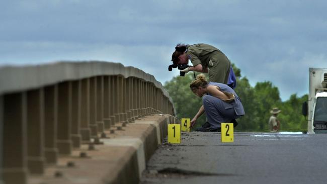 Crime scene examiners take pictures on the Adelaide River bridge. PICTURE: Michael Marschall