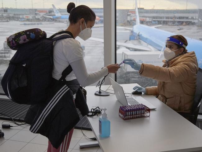 A passenger of a flight from South Africa is tested for coronavirus at Amsterdam Schiphol Airport. EU restrictions may soon be applied to Australians. Picture: Pierre Crom/Getty Images