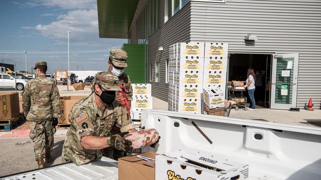 Members of the Texas Army National Guard help load cars with boxes of food during a distribution at the Odessa Food Pantry in Odessa, Texas, in June. Picture: Cengiz Yar