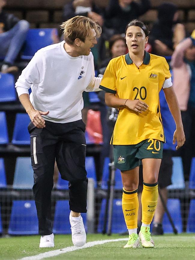 Sam Kerr gets a word or two of advice from coach Tony Gustavsson (L).