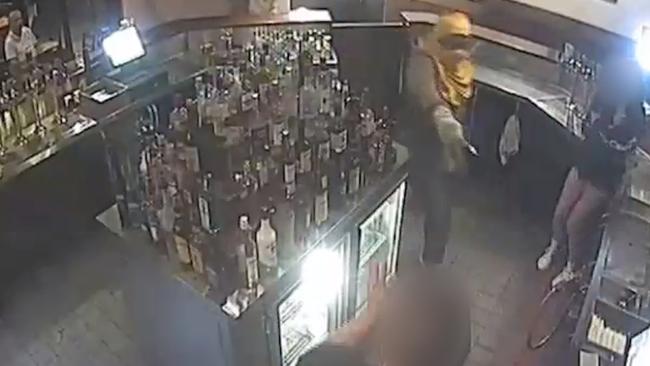 Police have released CCTV of the moment an inner-city hotel was robbed at knifepoint last month.