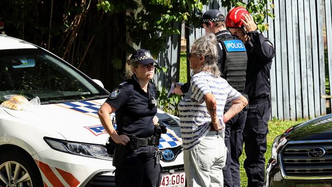 Queensland Police officers and fire fighters attend the scene of a fatal house fire that claimed the life of a man. Picture: Brendan Radke