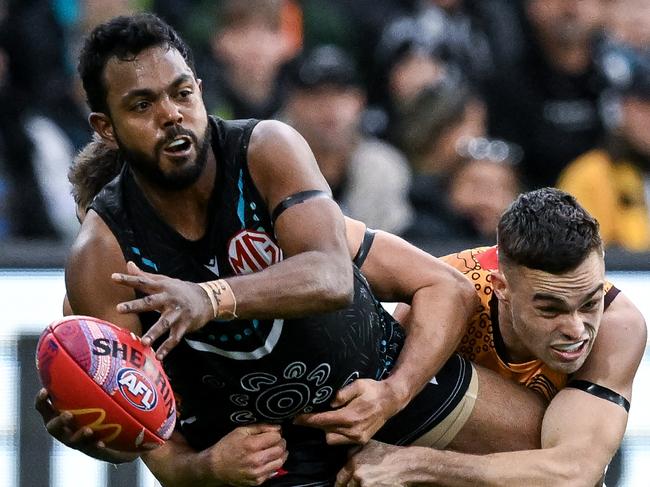 ADELAIDE, AUSTRALIA - MAY 19:   Willie Rioli of the Power   tackled by  Karl Amon of the Hawks during the round 10 AFL match between Yartapuulti (the Port Adelaide Power) and Hawthorn Hawks at Adelaide Oval, on May 19, 2024, in Adelaide, Australia. (Photo by Mark Brake/Getty Images)