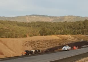 Photo of a dump truck that rolled on the Second Range Crossing this morning on Postman's Ridge Rd. Photo: Contributed.