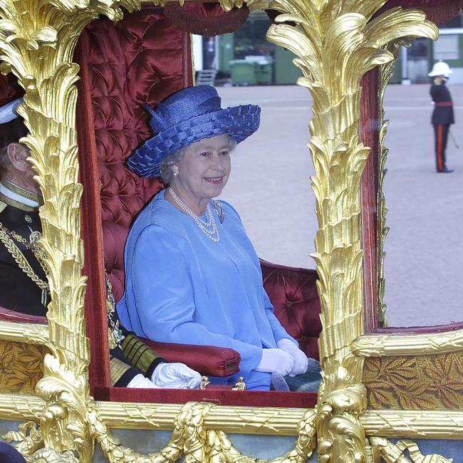 The Queen leaves Buckingham Palace in a gold state coach. Picture: Arthur Edwards.