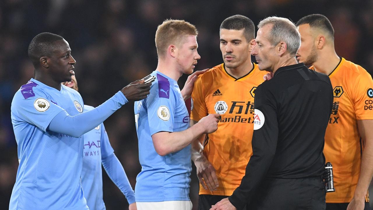 Manchester City's French defender Benjamin Mendy talks to the referee Martin Atkinson