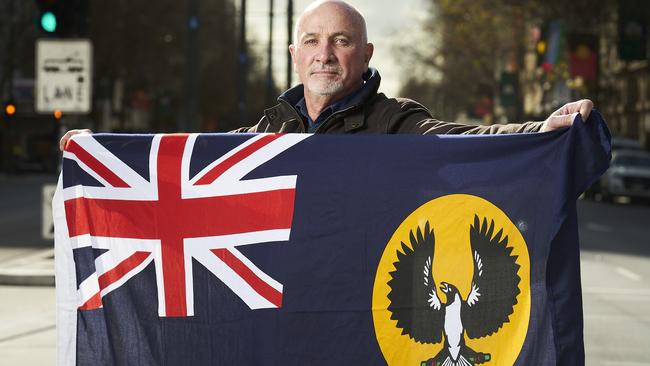 Keen bird watcher Ian Philp with the SA state flag. Picture: Matt Loxton