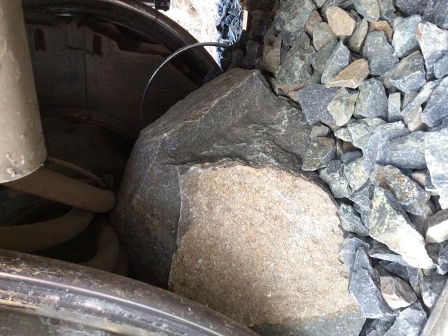 A large rock stuck under a train wheel. Picture: SUPPLIED