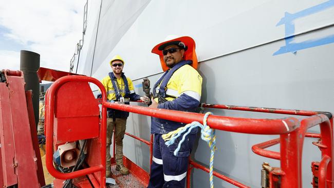 British Navy ship HMS Spey has docked at the Tropical Reef Shipyard for maintenance work, the first time a British warship has undergone maintenance at the Port of Cairns. Marine workers Tupoumatatika Meremere and Dyfan Tinnuche work on the hull on HMS Spey. Picture: Brendan Radke