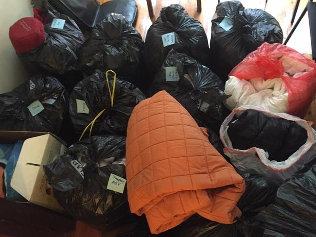 Bags of clothes for the homeless pile up in Brandon Cowan’s living room in St Ives.