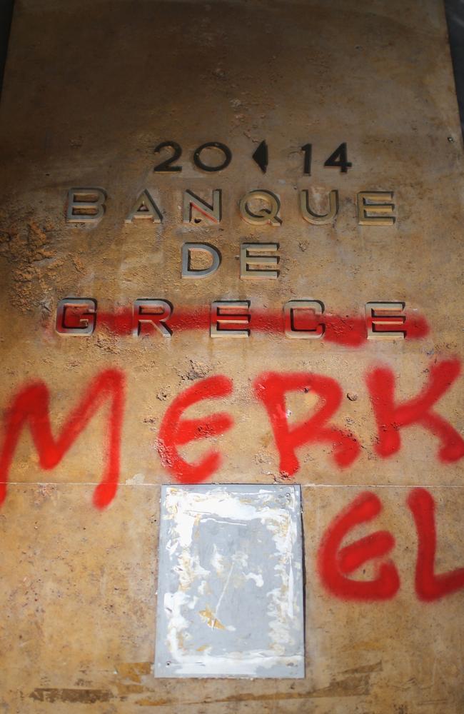 Protest ... a Bank of Greece sign is defaced with graffiti to read 'Banque de Merkel' in Athens, Greece. Picture: Christopher Furlong/Getty Images