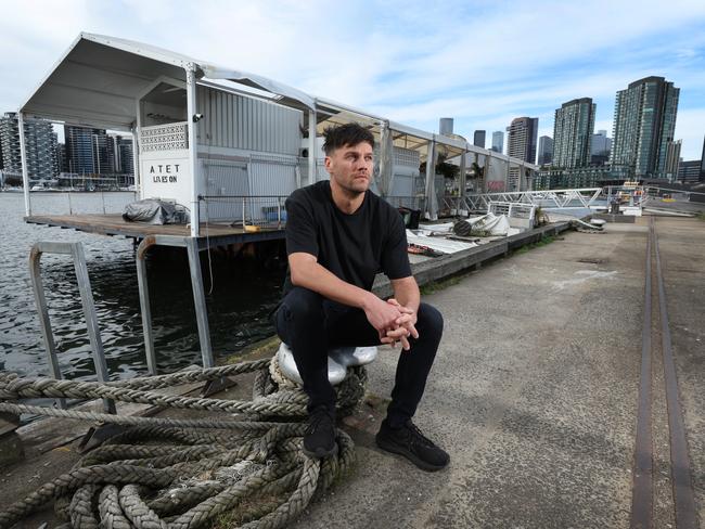 Jake Hughes at the barge, which is languishing at Docklands. Picture: David Caird