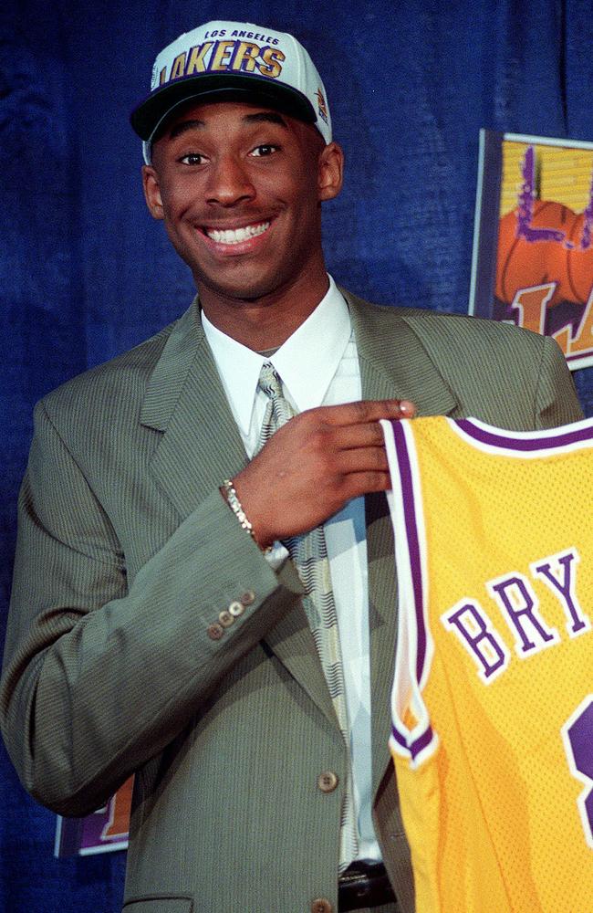 Kobe Bryant, 17, jokes with the media as he holds his Los Angeles Lakers jersey during a news conference at the Great Western Forum in Inglewood, California. Picture: Getty