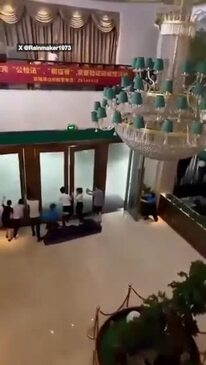 Horror moment hotel staff try close door as typhoon hits