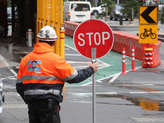 Construction industry insiders say people holding signs on mega projects could earn up to $110,000 per year. Picture: David Crosling