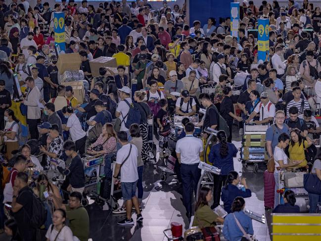 Long queues of passengers form at the check-in counters at Ninoy Aquino International Airport. Picture: Ezra Acayan/Getty Images